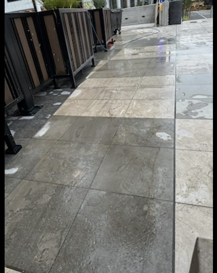 Commercial concrete cleaning or pressure-washing equipment in use