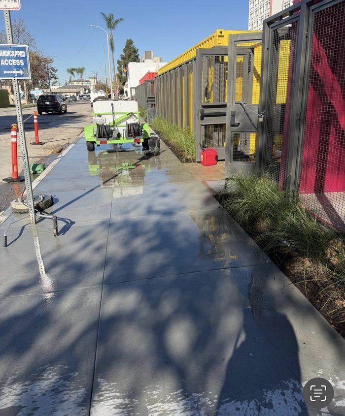 Commercial streetscape sidewalk cleaning along a retail frontage
